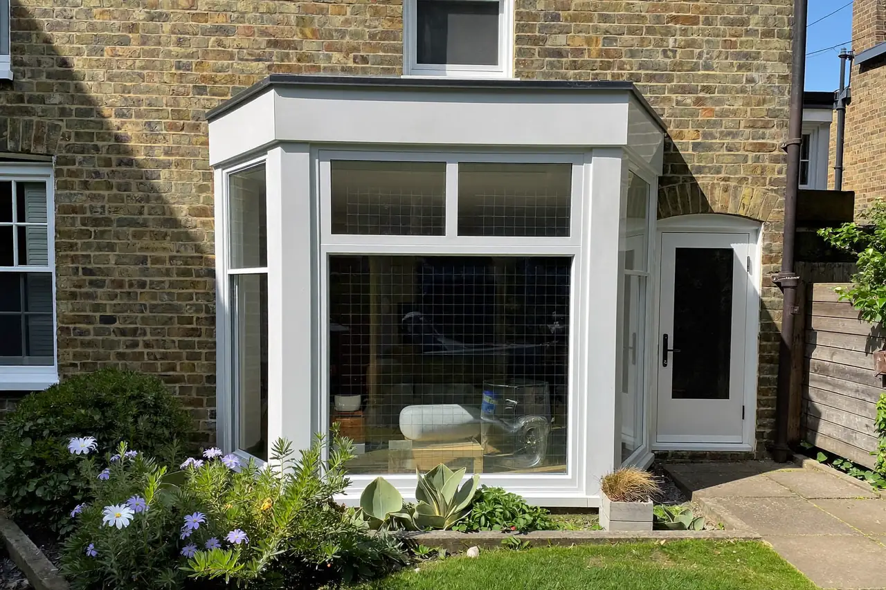 Bay window fitted to the front of a brick semi-detached house