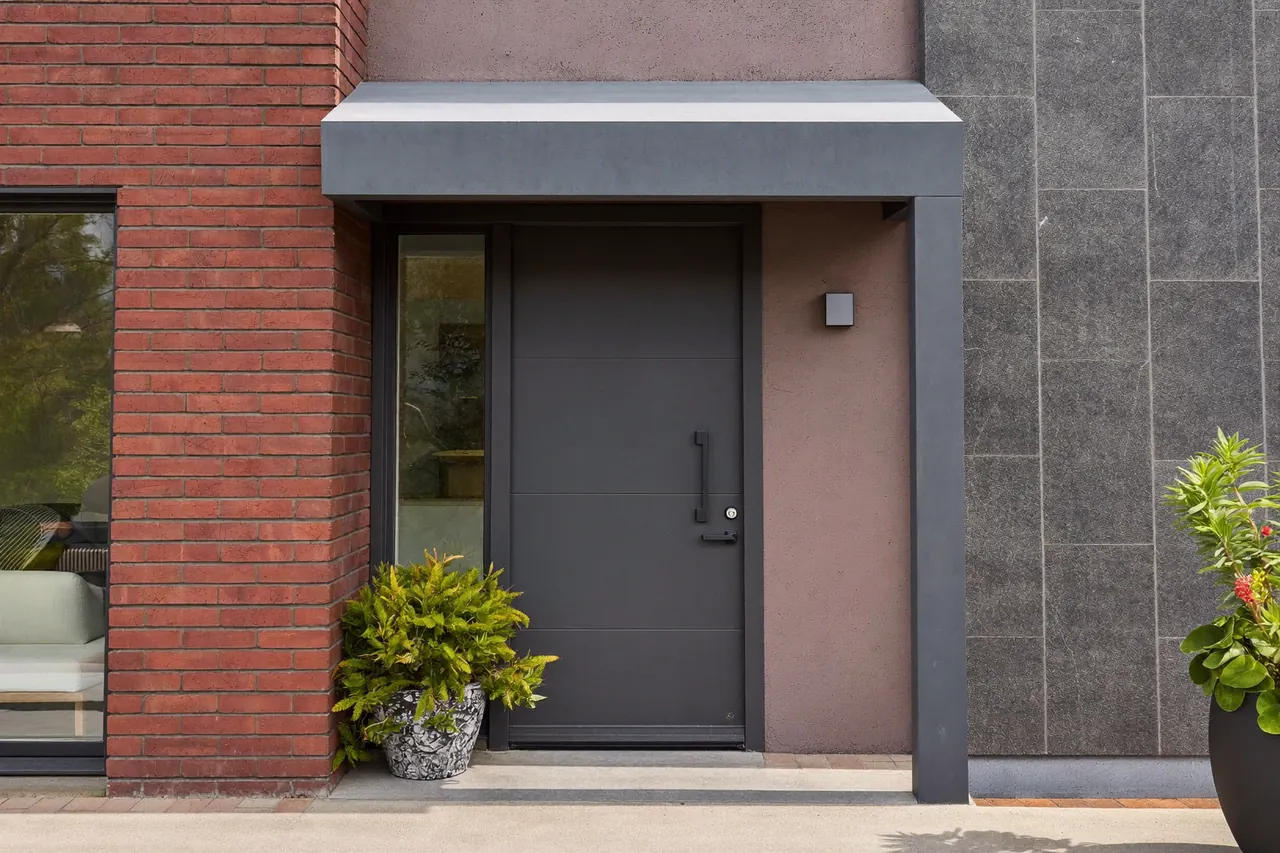 New front door and porch on a modern brick home