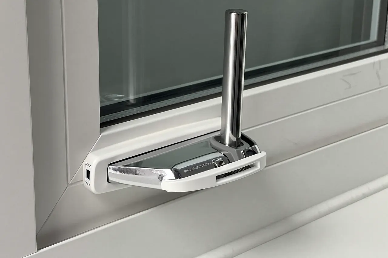 Close-up of a window handle and multi-point lock on a new frame
